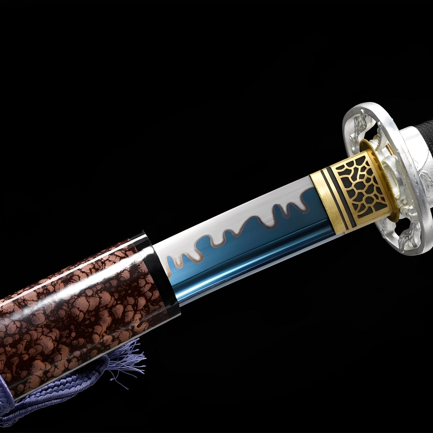 Earthbreaker Katana close-up showing polished blade with blue section and white molten drip pattern, chrome dragon tsuba, honeycomb brass habaki, and black ito