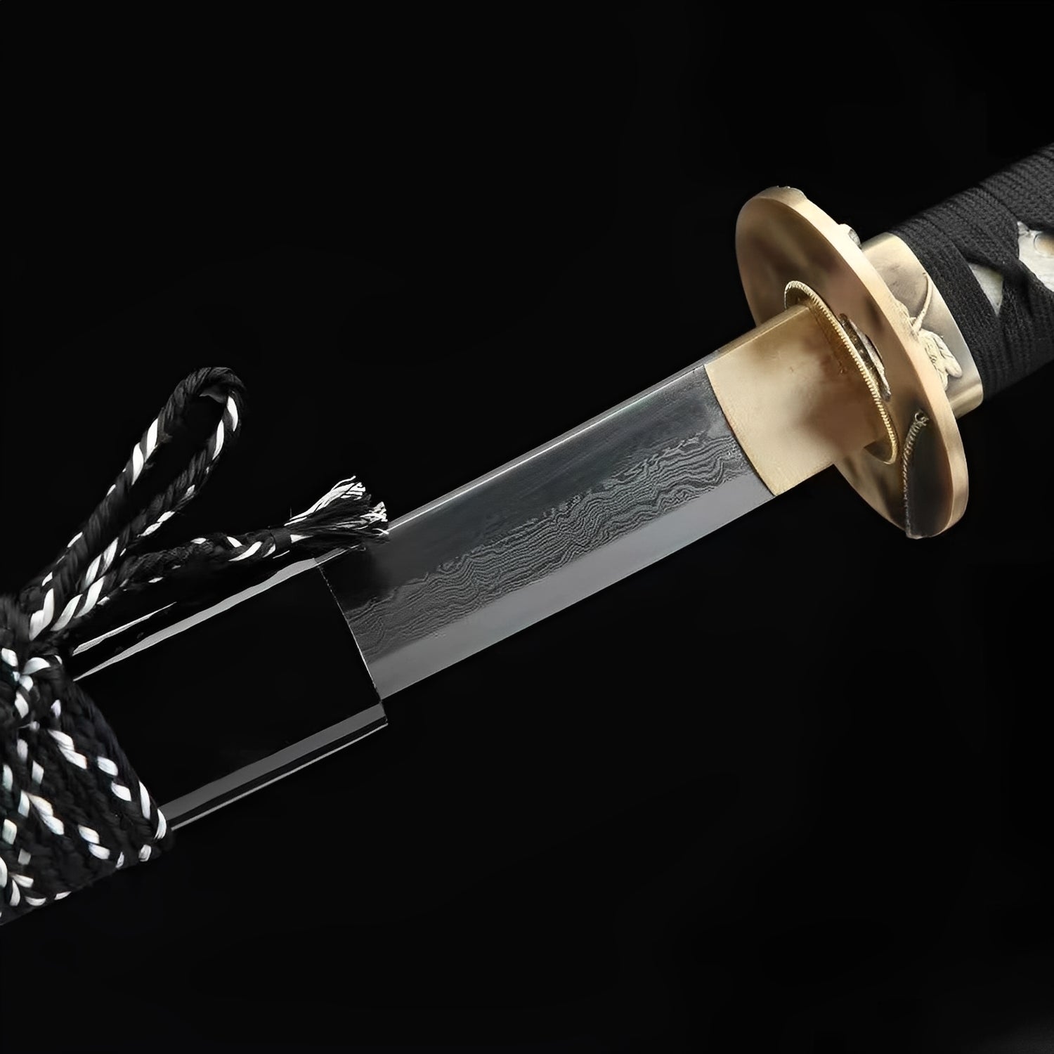 Kamakura Katana close-up showing Damascus blade with dense folded grain pattern, smooth brass oval tsuba with leaf motif, copper habaki, and black cotton ito over genuine rayskin
