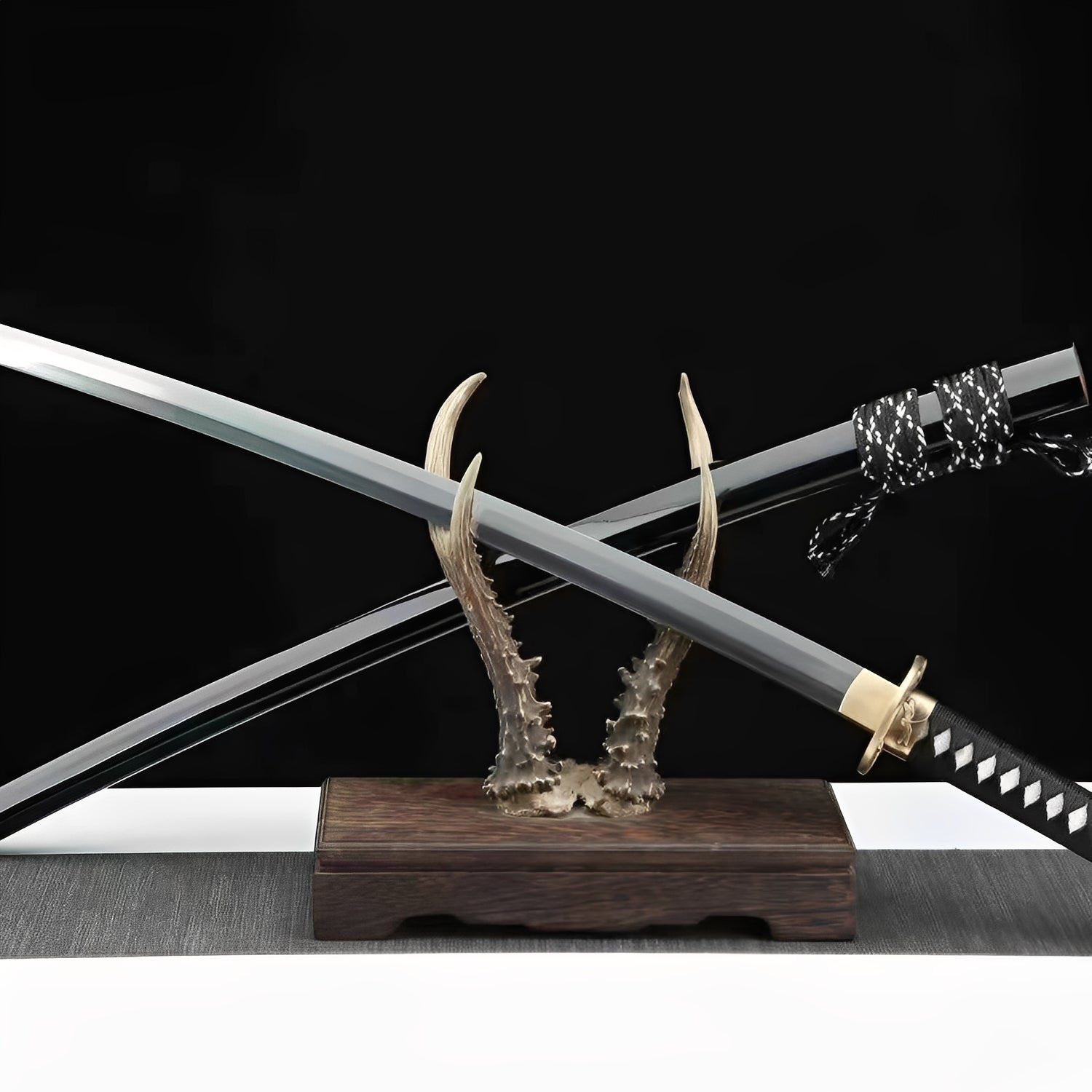 Kamakura katana complete set with black glossy saya, black-white twisted sageo, brass fittings, and sculptural bronze antler stand