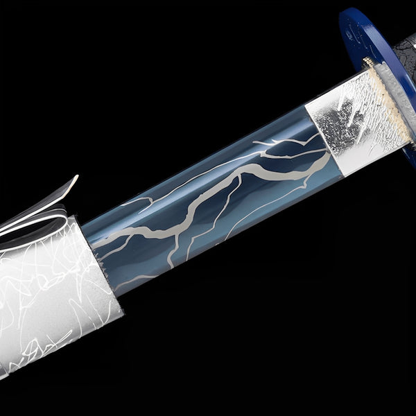 Lightning Katana close-up showing blue blade section with raised white lightning bolts, blue circular tsuba, iron-alloy textured habaki, and black-white synthetic leather ito over genuine rayskin