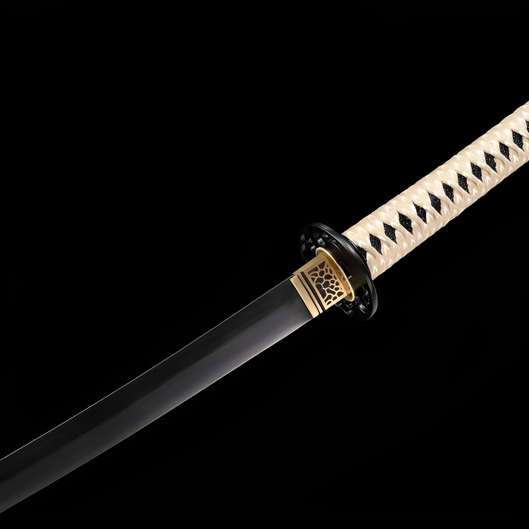 Obsidian katana habaki detail showing bronze hexagonal honeycomb openwork pattern between black blade and black guard