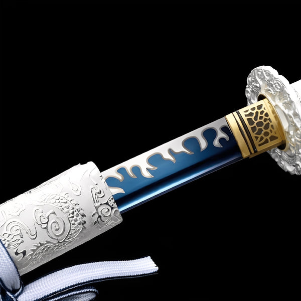 Seiryu Enbu Katana close-up showing blue manganese blade with white flame overlay pattern and hamon line, chrome iron dragon tsuba, brass honeycomb habaki, and white cotton ito with gold-plated menuki