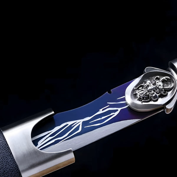 Raisenga katana blade detail showing royal blue section with white wind pattern near chrome habaki