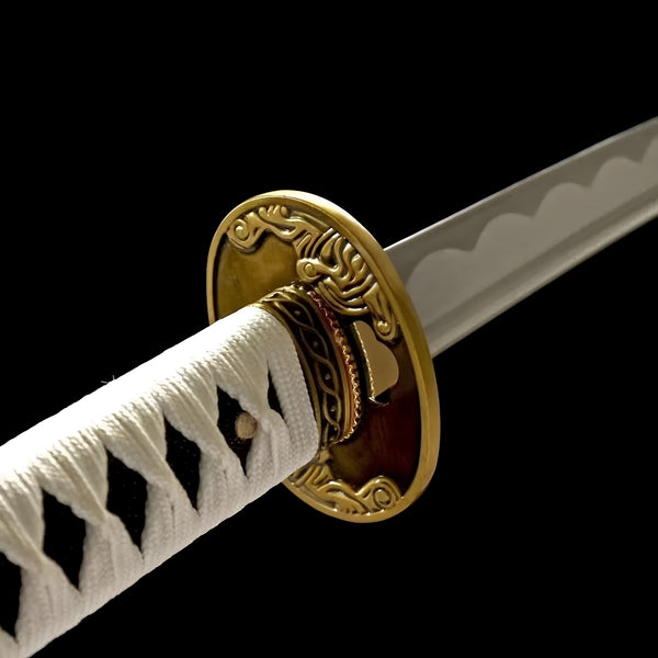 Vergil Yamato katana blade detail showing hamon temper line on polished 1060 carbon steel near gold habaki