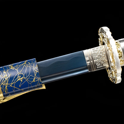 Aoi Seika Katana close-up showing blue 1060 blade with hamon, chrome-gold dragon openwork tsuba with floral accents, silver seigaiha habaki, and platinum white PU leather ito with gold chrysanthemum menuki