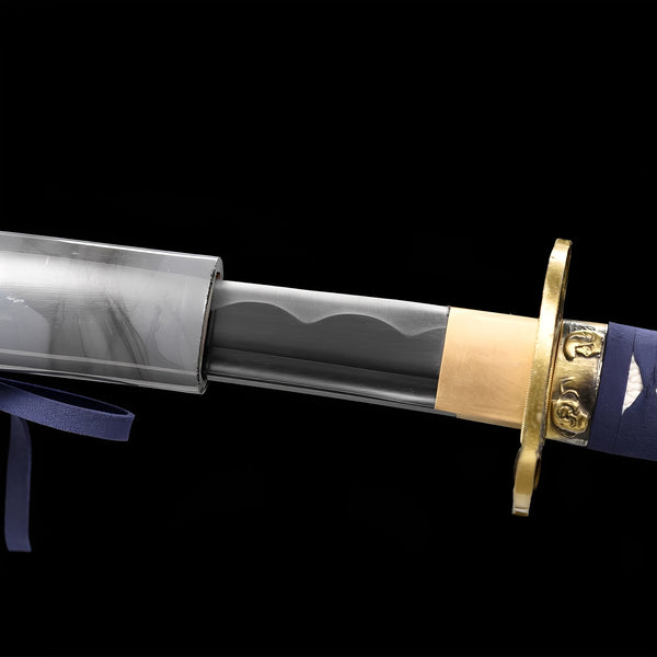 Arashi no Kiri Katana close-up showing storm-gradient blade with white bamboo engravings and hamon, brass dragon tsuba, and navy blue cotton ito over synthetic rayskin