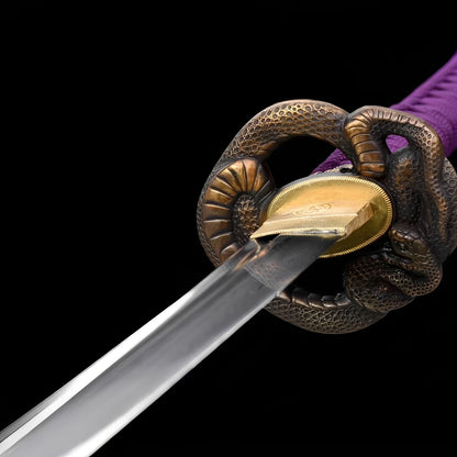 Baioretto katana tsuba detail showing three-dimensional shishi lion-dog emerging from dual-tone copper guard with gold brass rim and mon habaki