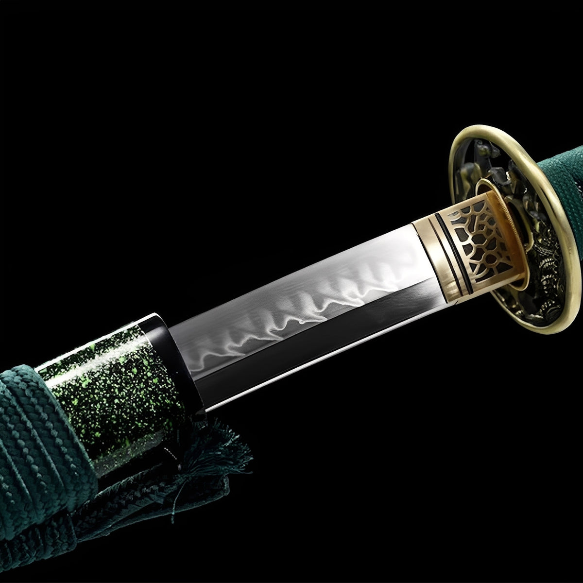Emerald katana blade beside its green-speckled saya and green handle