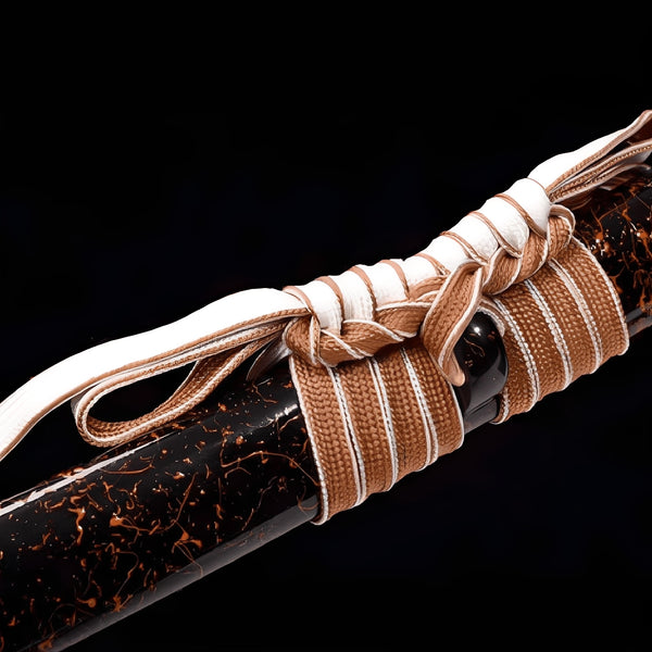 Enbanaito katana saya detail showing copper-orange lightning vein pattern on deep black lacquer surface