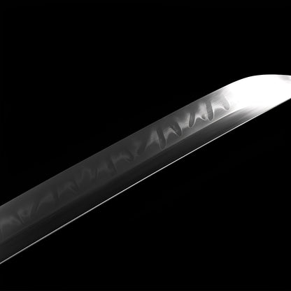 Imperial katana blade detail showing authentic choji clove-pattern hamon on polished T10 steel with dragon horimono near habaki
