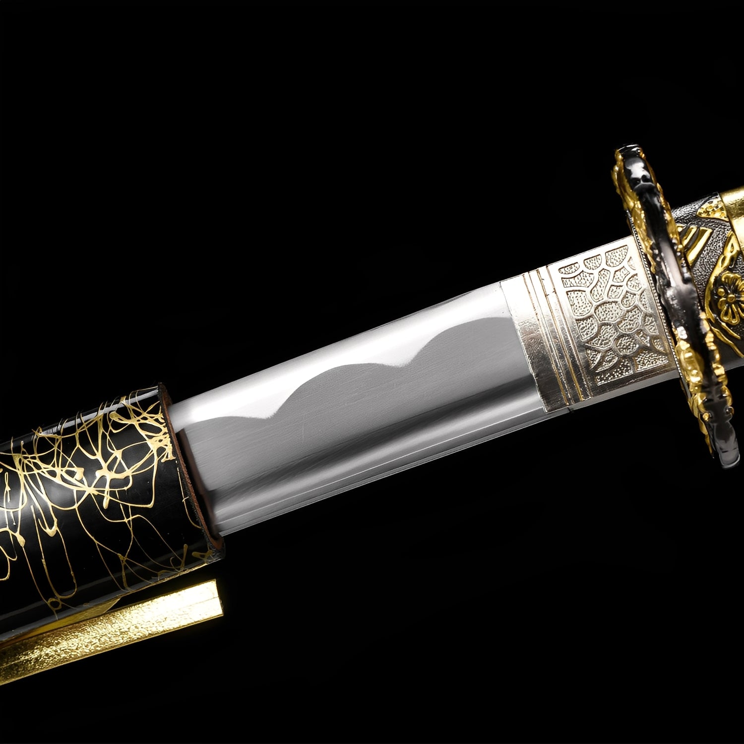 Kinkuro Katana close-up showing polished 1060 blade with hamon, chrome-gold dragon openwork tsuba, silver engraved habaki, and gold PU leather ito with chrysanthemum menuki over synthetic rayskin