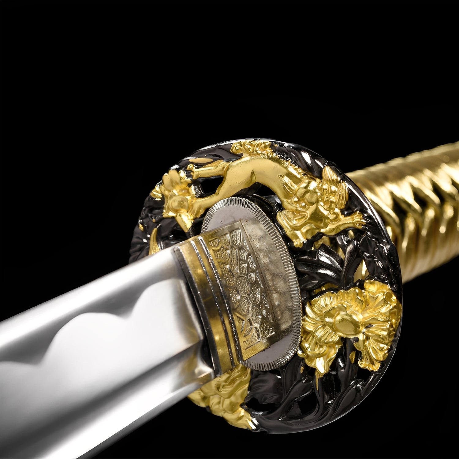 Kinkuro katana habaki detail showing silver surface with dense floral scroll engravings beneath chrome-gold dual-tone dragon tsuba