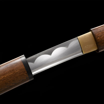 Mokuro Kageuchi Katana close-up showing polished 1060 blade with scalloped hamon line, brass rectangular habaki, iron-alloy tsuba, and natural rosewood handle with visible wood grain and mekugi pin