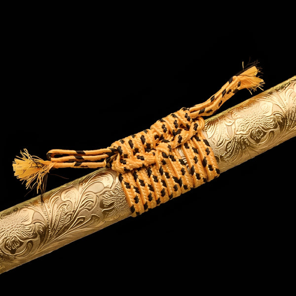 Ogon Ryushi katana saya detail showing sculpted dragon and cloud relief carved directly into gold lacquered wood surface