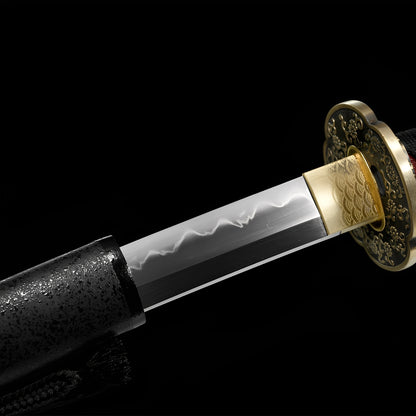 Shinku Raijin Katana close-up showing T8 blade with authentic gunome hamon, dual-tone copper tsuba with sakura-seigaiha relief and brass rim, seigaiha-engraved habaki, and black cotton ito over red genuine rayskin