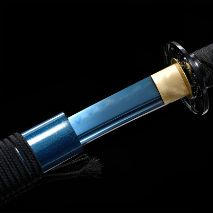 Azure Spirit Katana close-up showing blue mirror-finish 1095 blade emerging from matching blue saya, iron openwork tsuba, brass habaki, and black ito over synthetic rayskin