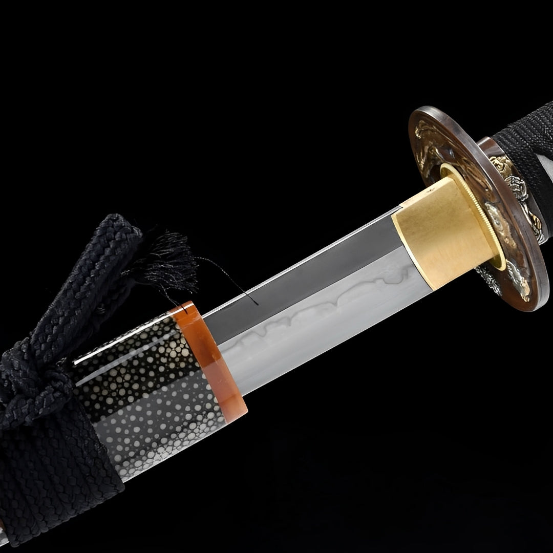 Ginto T10 katana beside its rayskin-covered saya and amber scabbard opening