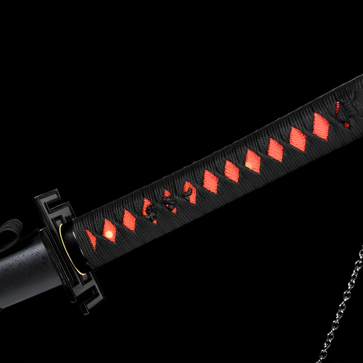 Black Ichigo handle wrap over red material with a chain at the end