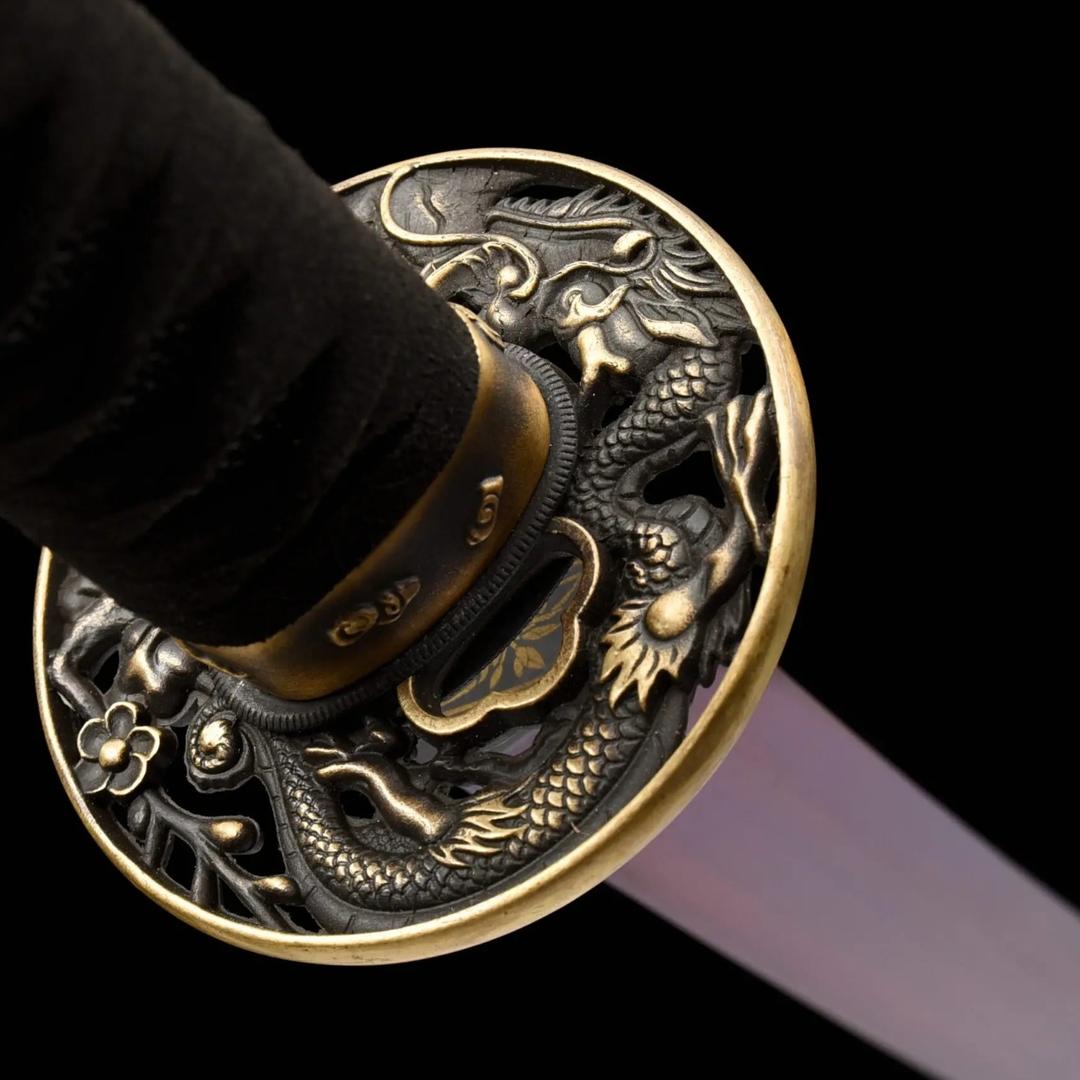 Dragon and phoenix relief on the copper guard of the Purple Blade katana