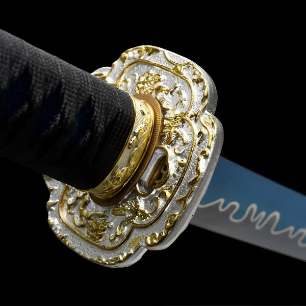 Aonami Wakizashi close-up showing blue T10 blade with painted wave crest pattern near habaki, iron dragon tsuba in silver-gold, and black-blue cotton ito