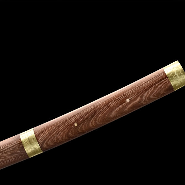 Wooden katana full view on red display stand with natural grain wood saya, brass koiguchi and kojiri fittings, and bronze shishi figurine