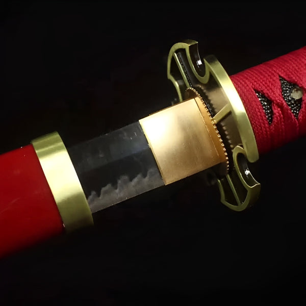 Zoro Katana close-up showing brass openwork tsuba, polished blade with hamon line, red cotton ito over black rayskin handle